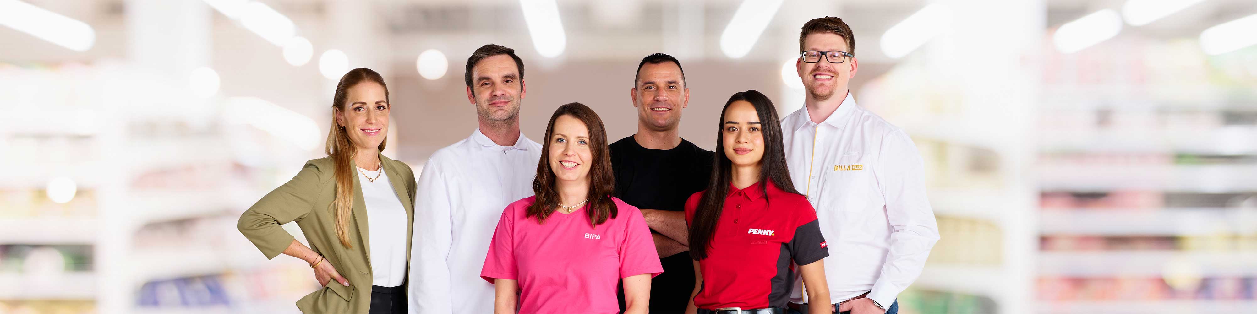 Smiling employees of the various brands of the REWE GROUP